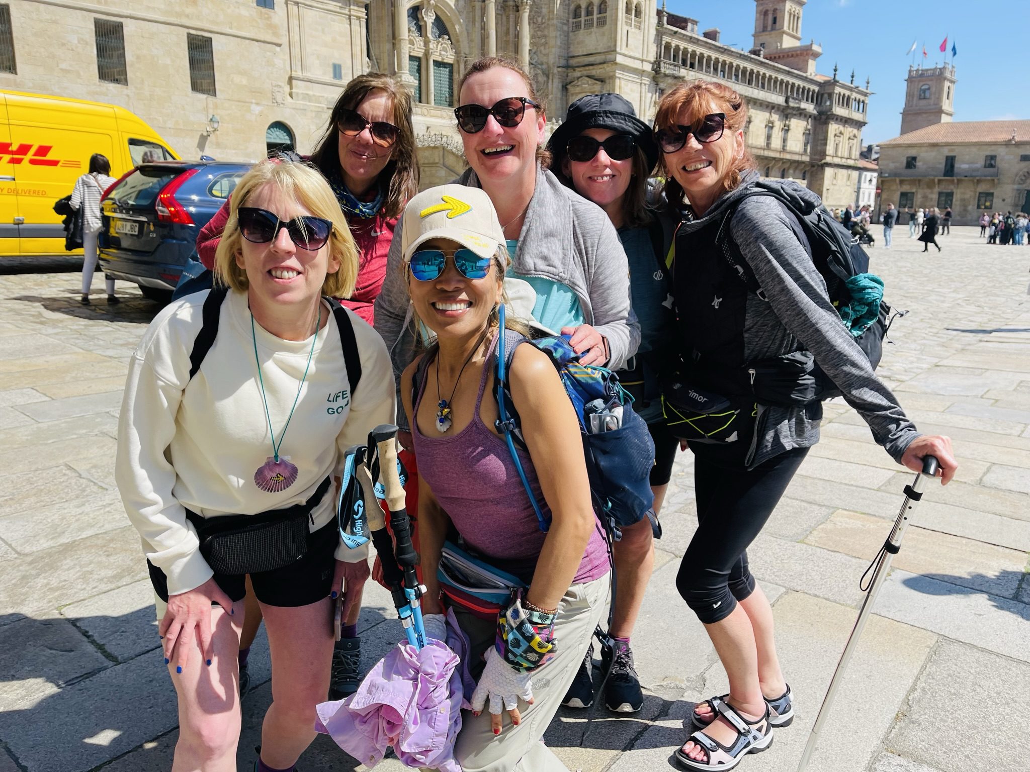 Group of women smiling outdoors together.