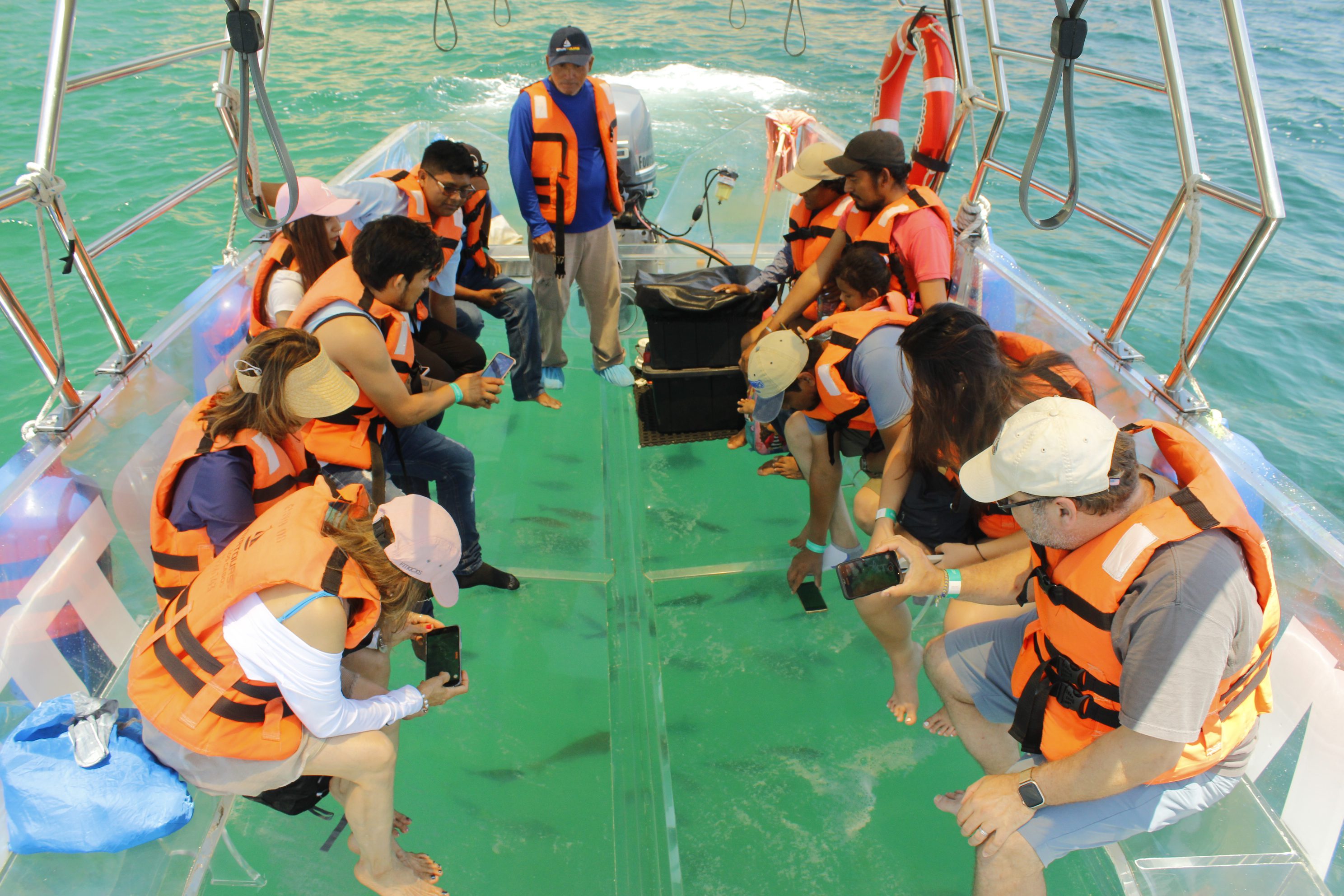 People in life jackets on a boat.