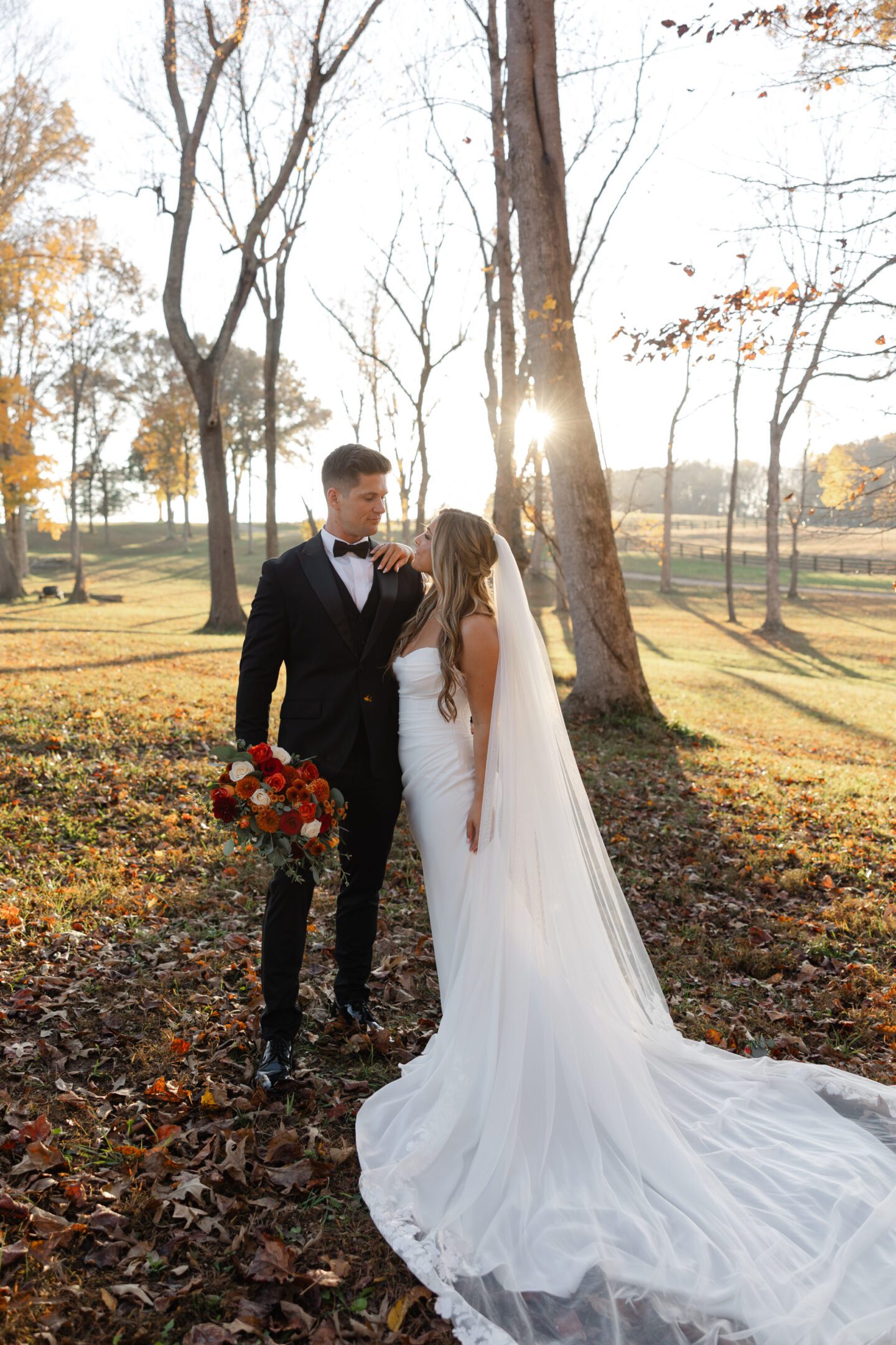 Bride and groom in autumn forest setting.