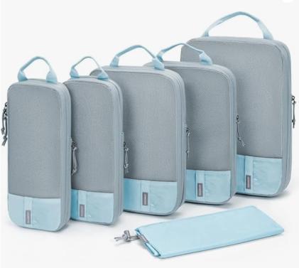 Five gray and blue travel packing cubes.